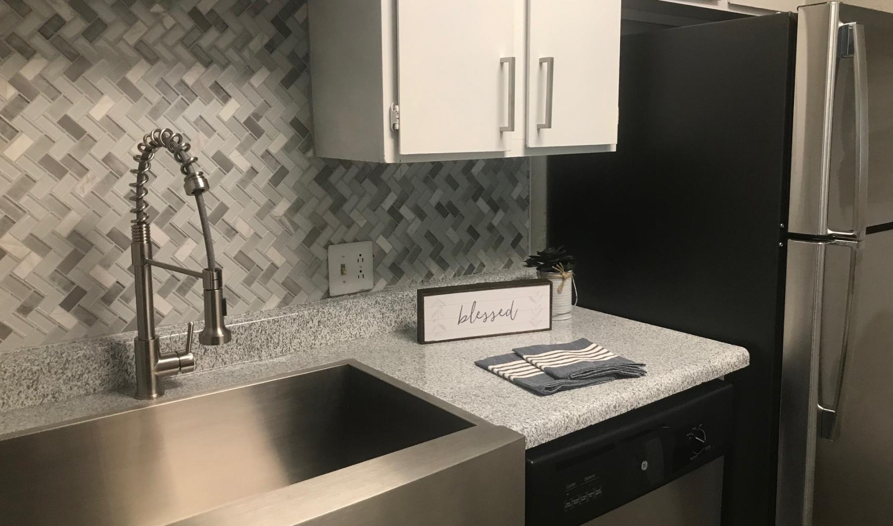 a kitchen with a sink and a refrigerator