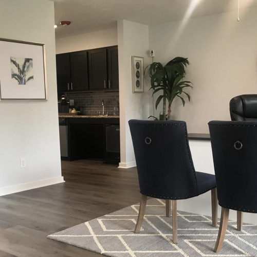 a room with chairs and a rug