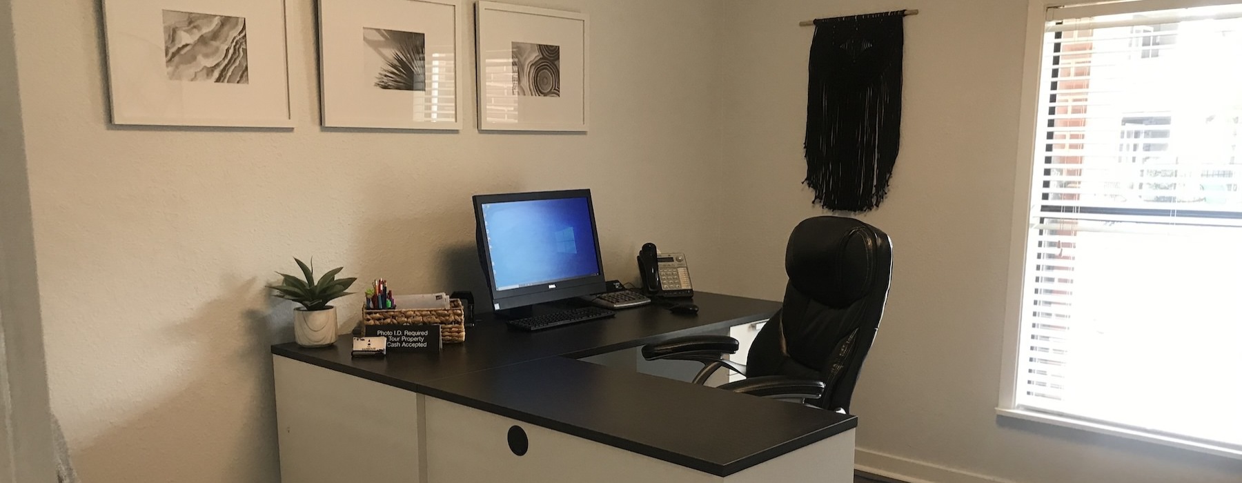 an office with a desk, chair and a computer