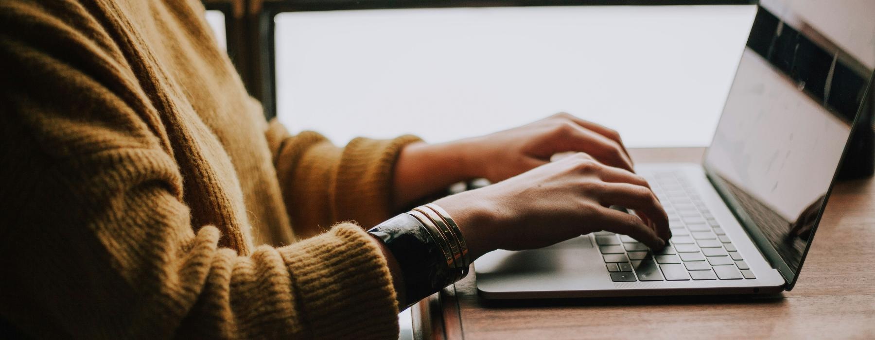 a person typing on a laptop