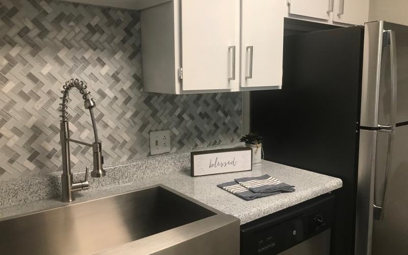 a kitchen with a sink and a refrigerator
