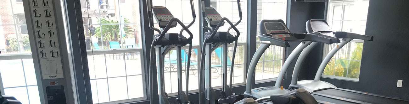 fitness center with treadmills and a poolside view