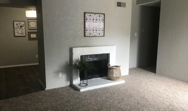 living area that includes cozy fireplace & stylish carpet