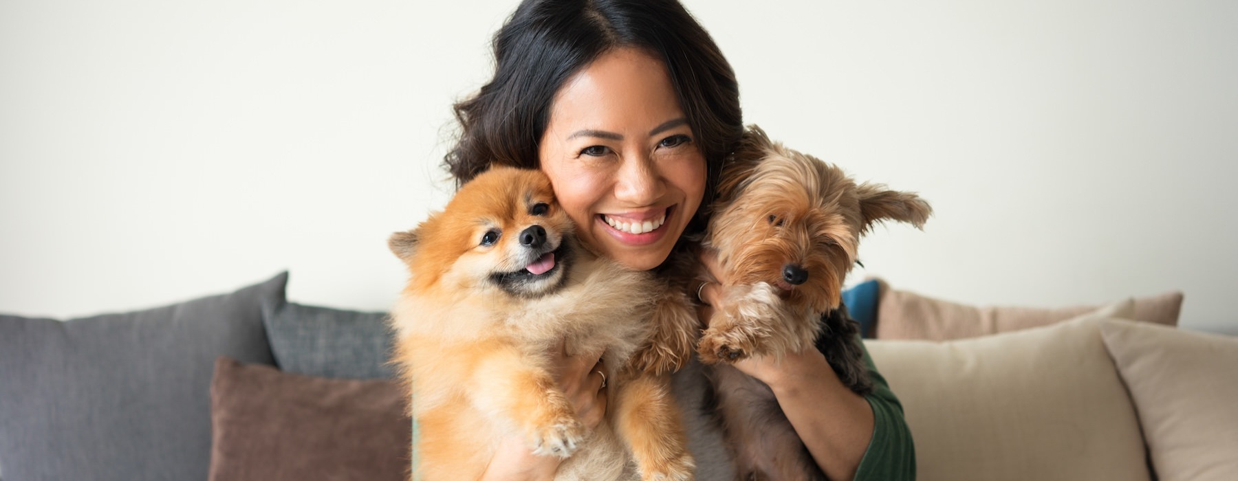 a woman holding dogs