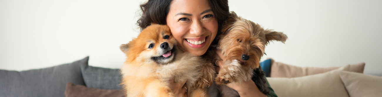 woman's face and 2 small dogs