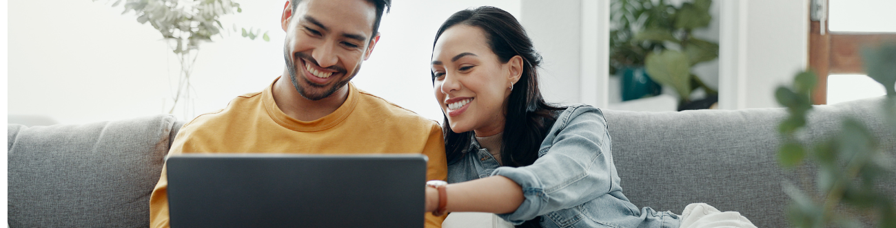 Couple in an apartment looking at a laptop