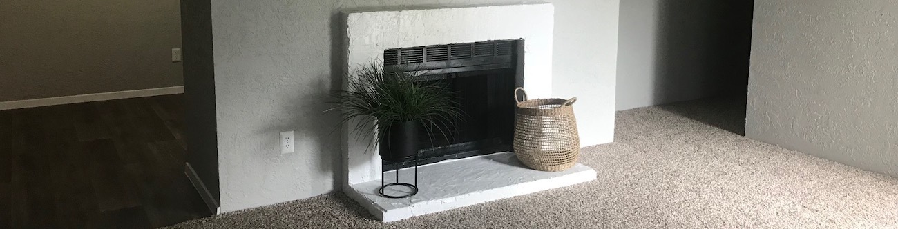 area of living room that connects to kitchen with faux wood floors